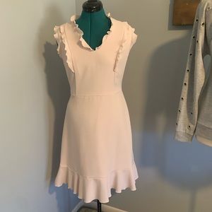 Demure pale pink ruffled dress. Knee length